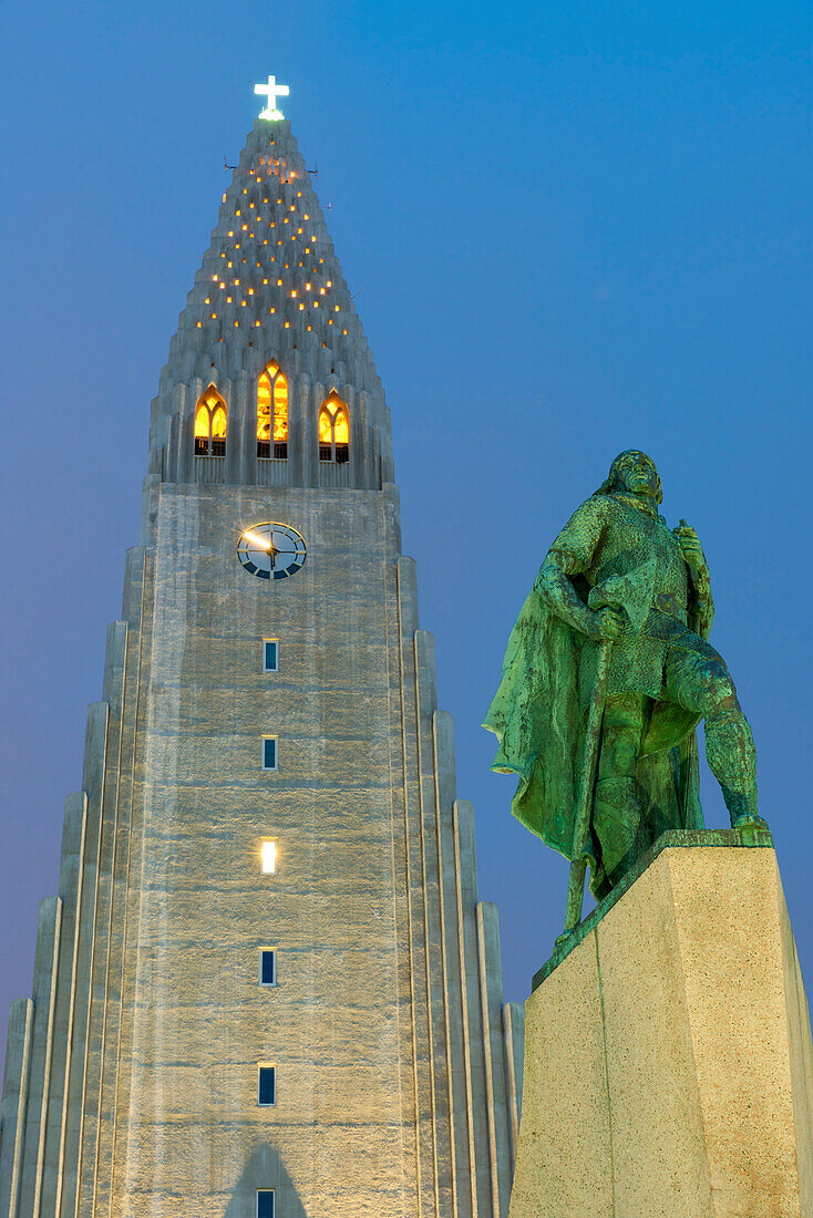 The Hallgrims Church with a statue of Leif Erikson in the foreground lit up at night, Reykjavik, Iceland, Polar Regions