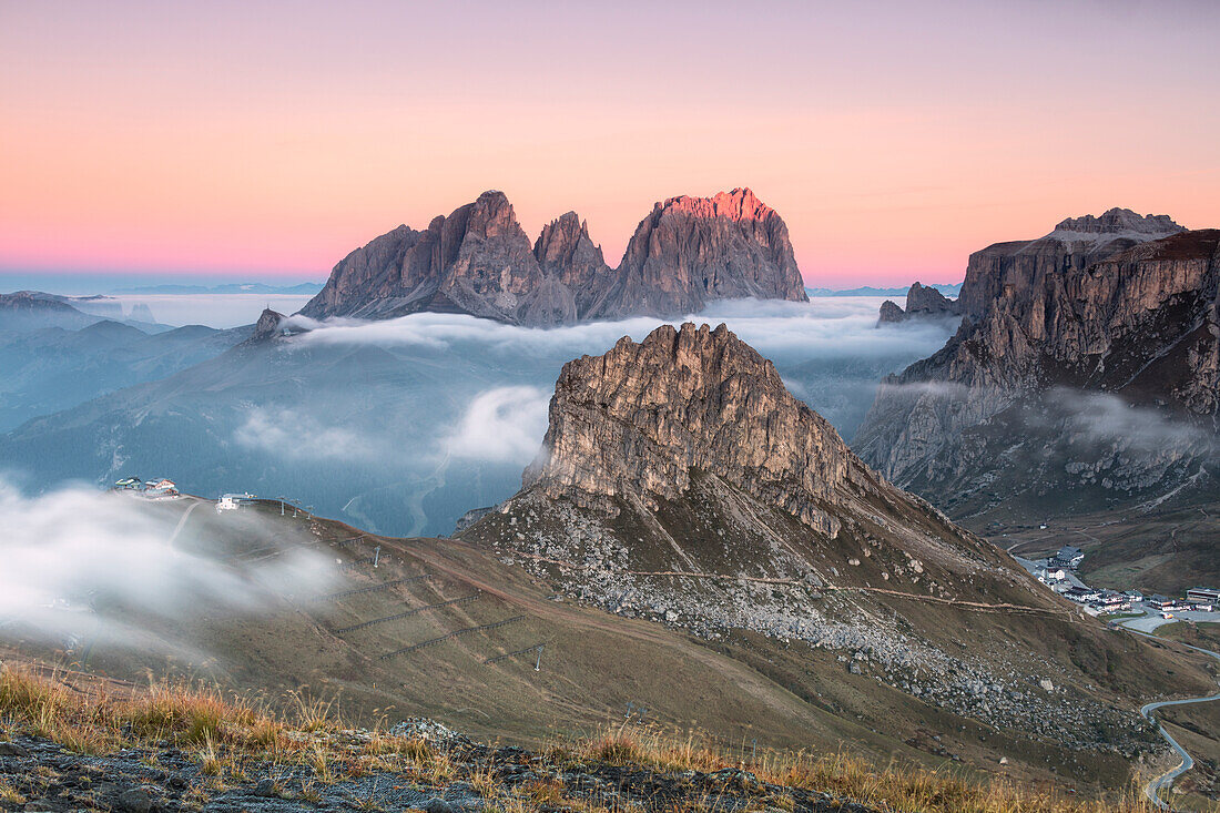 Pink sky and mist on Sass Beca and Sassolungo seen from Cima Belvedere, Canazei, Val di Fassa, Trentino-Alto Adige, Italy, Europe