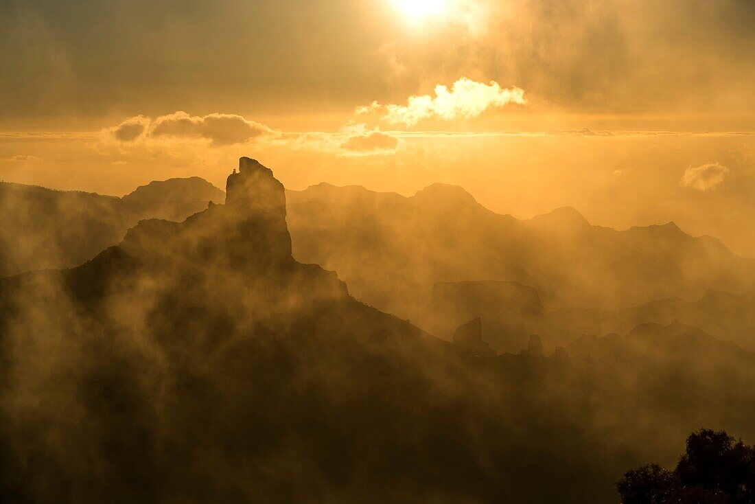 Foggy landscape around the Monolith Roque Bentayga at dusk, Gran Canaria, Canary Islands, Spain.