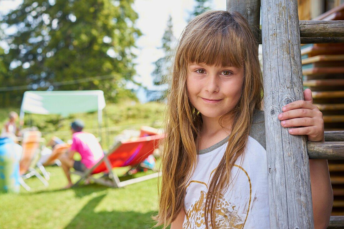 Portrait of playful young female child during family meetup in rural scene in Bavaria, Germany