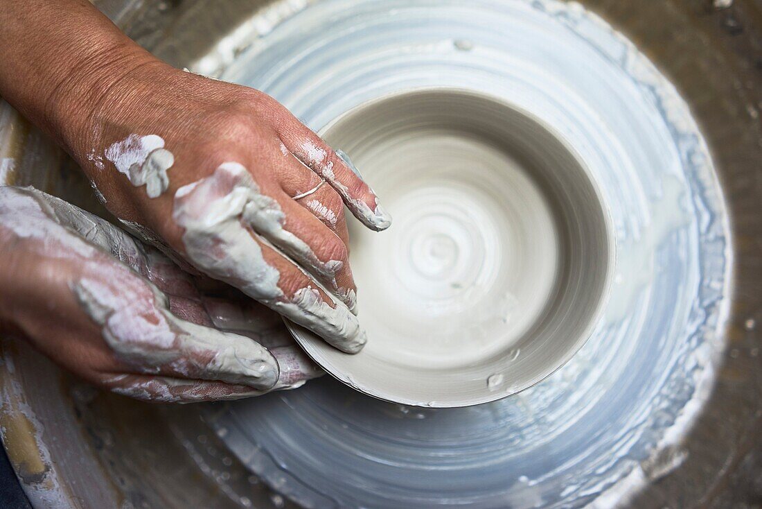 Passionate hands creating pottery with natural clay