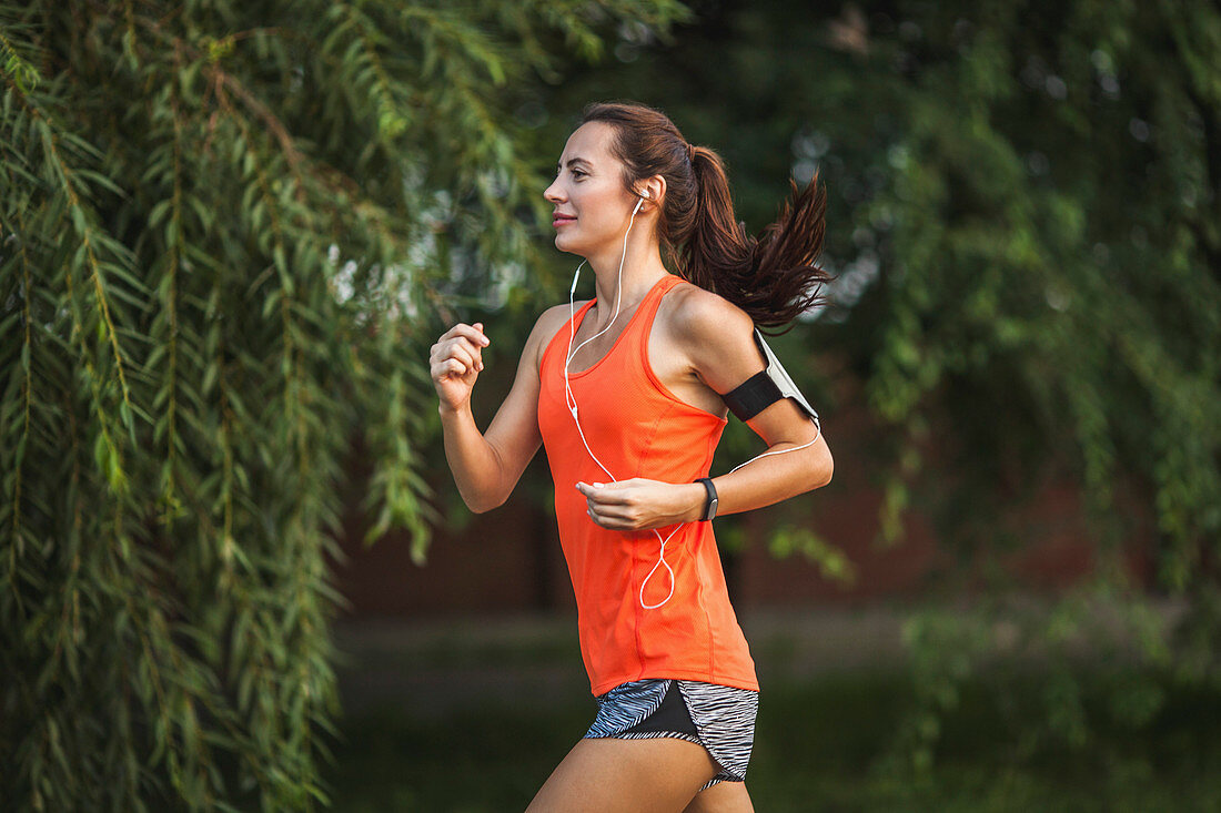 Side view of woman jogging at park