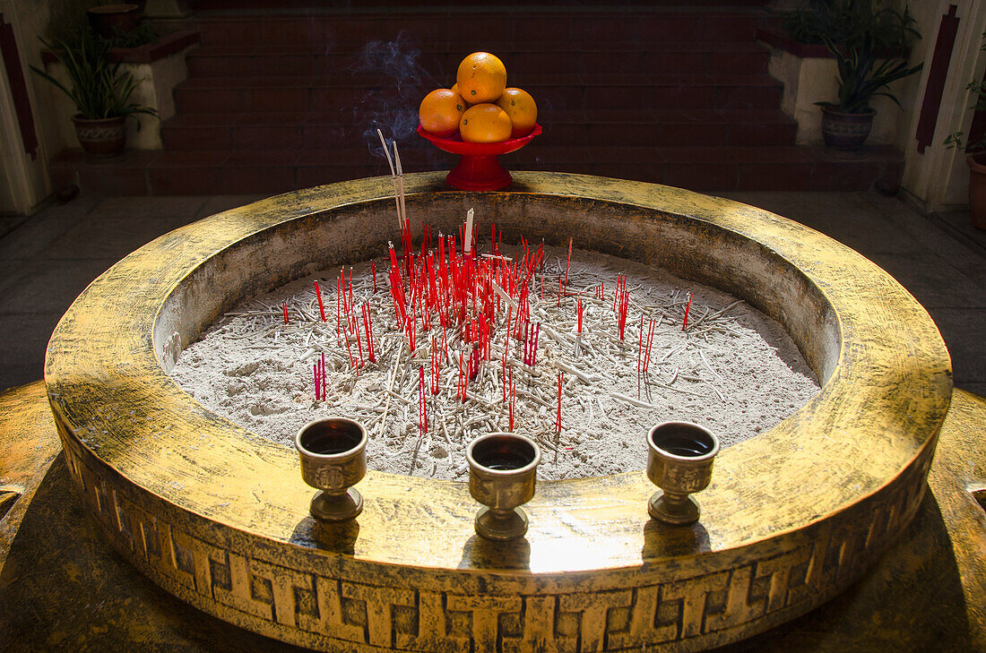 High angle view of incense sticks in container at temple