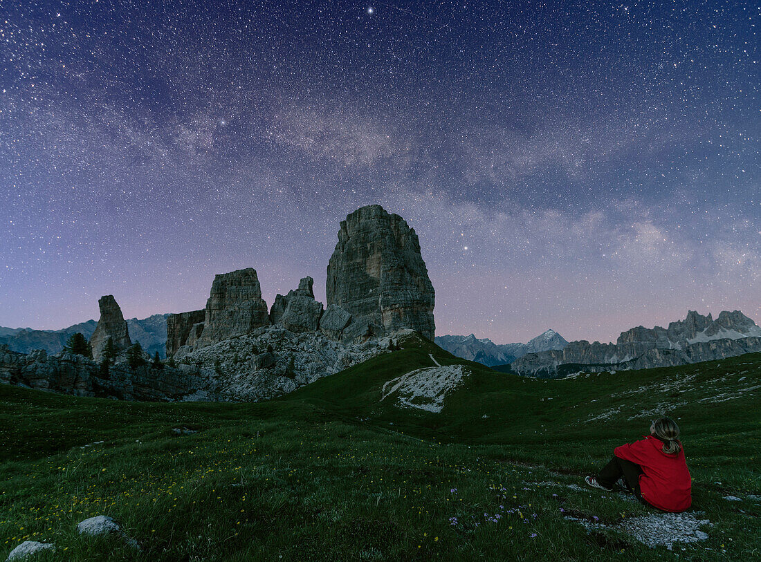 Cinque Torri group, Cortina d'Ampezzo, Veneto, Dolomites, Italy, Woman staring at starry sky