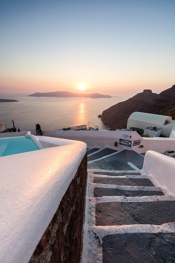 Sunset over the Aegean Sea seen from an alley of stairs of the old village of Firostefani Santorini Cyclades Greece Europe