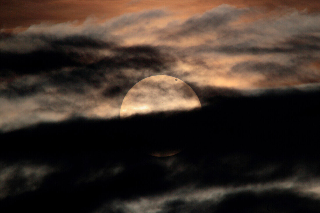 Venus transit over the Sun of 5 June 2012, with the sun behind dark clouds at sunrise, It won't happen again until December 2117, The picture has been taken from Monte Albenza, Province of Lecco, Lombardy, Italy