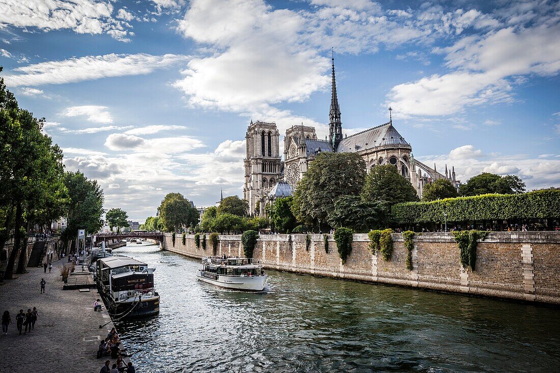 Notre Dame cathedral with puffy clouds, Paris, France.