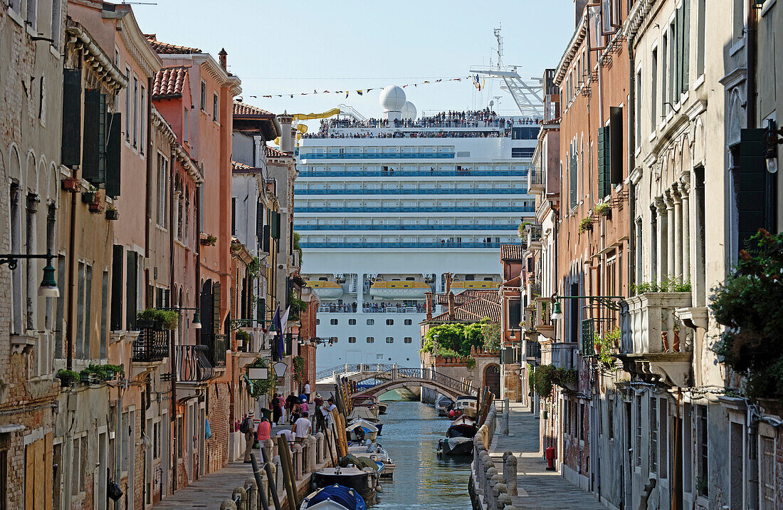 Huge cruise ship seen from canal in city, Venice, Veneto, Italy