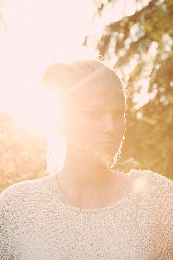 Close-up portrait of confident young woman on sunny day