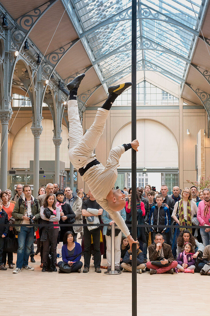 Europe, France, Paris (75), 3rd arrondissement, Le Marais, the 'Carreau du Temple'. April 25th, 2014. Opening day. Acrobatic show on a Chinese Pole by Rafael de Paula. It is a former clothes market that was redeployed in a cultural and sport center in 202