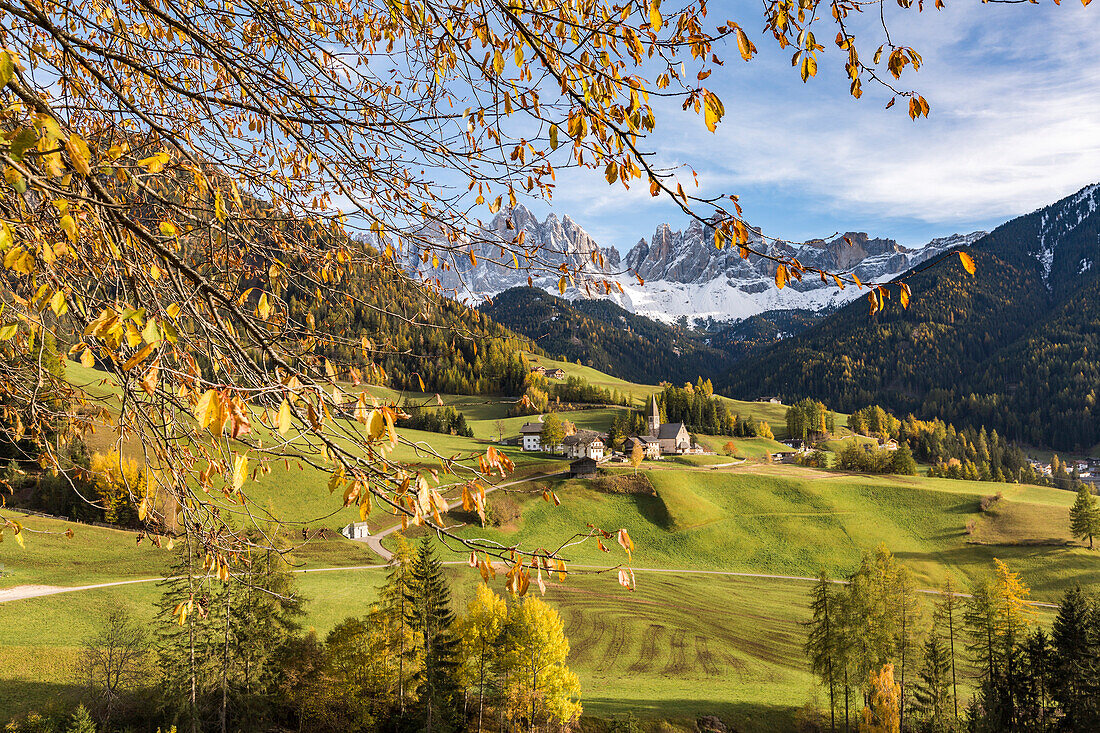 Dolomites village framed by autumnal leaves, Santa Maddalena, Funes, Bolzano, Trentino Alto Adige - Sudtirol, Italy, Europe