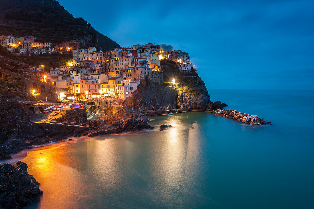 Long exposure of Manarola at dusk, Cinque Terre, Riviera di Levante, Liguria, Italy