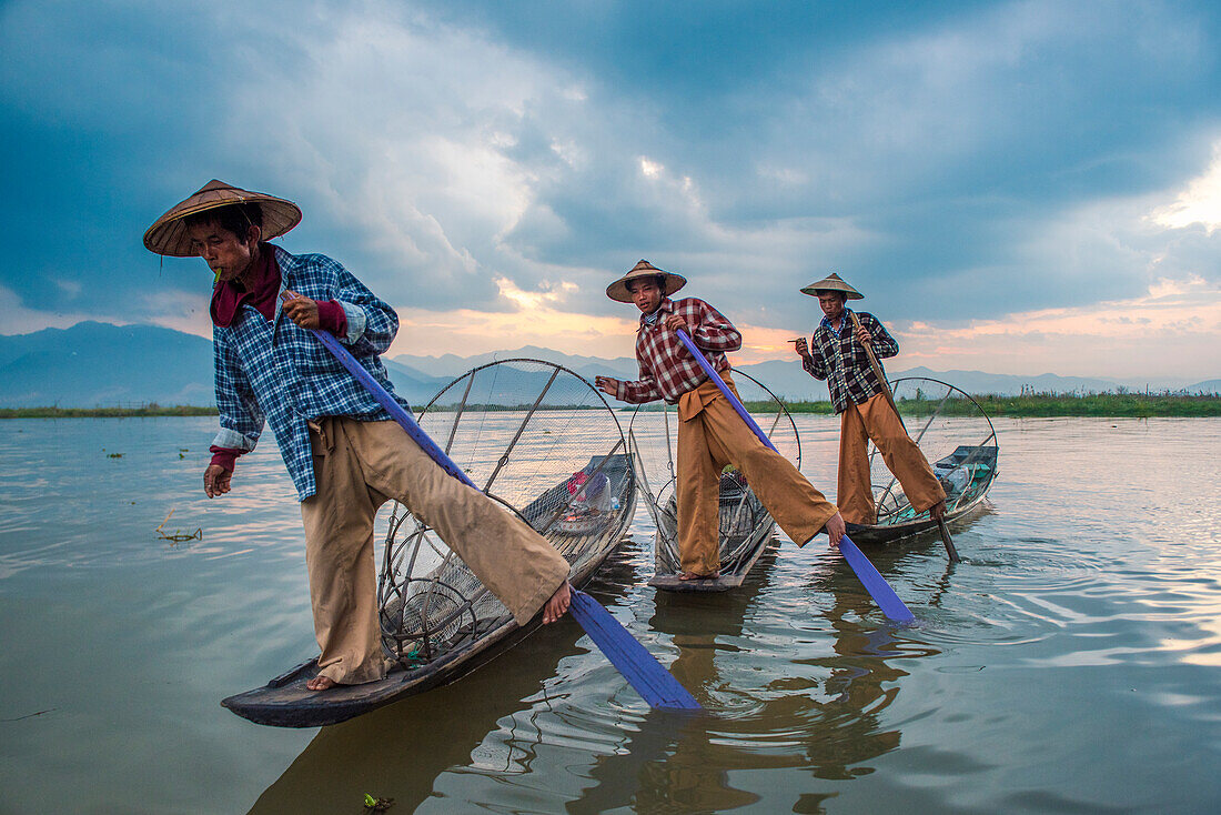 Inle lake, Nyaungshwe township, Taunggyi district, Myanmar Burma , Thee local fishermen rowing in row