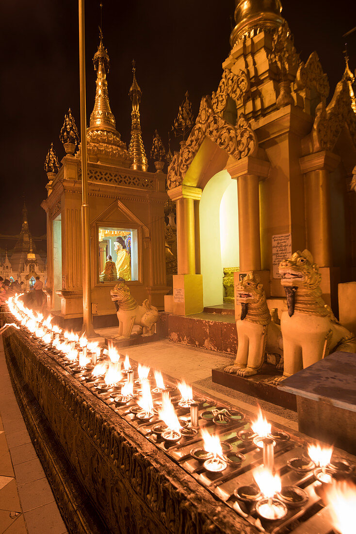 Yangon, Myanmar Burma , Rows of candles in the Shwedagon pagoda at night