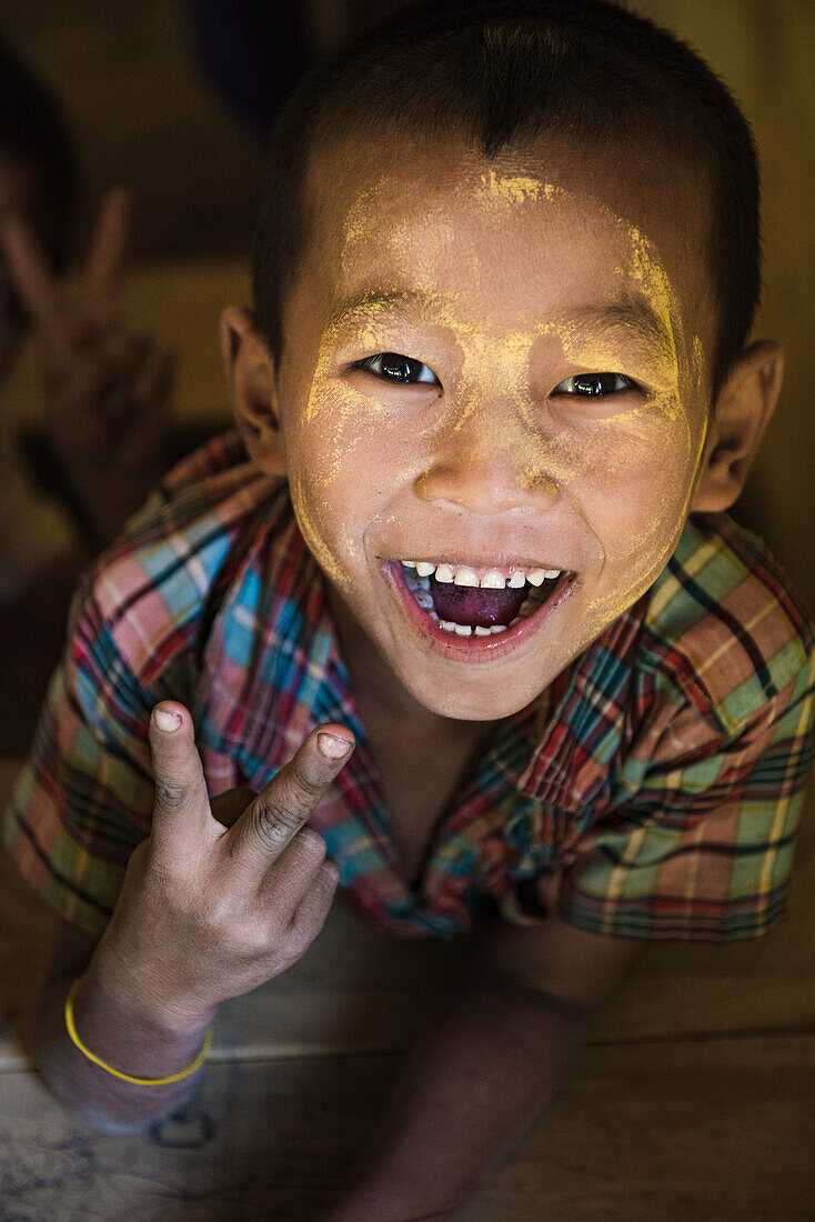 Rakhine state, Myanmar, Portrait of a Chin young boy laughing at the camera