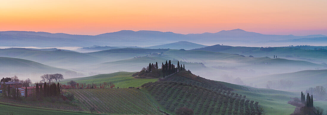 Valdorcia, Siena, Tuscany, Italy, Panoramic view of a tuscan farm on top of a hill at sunrise