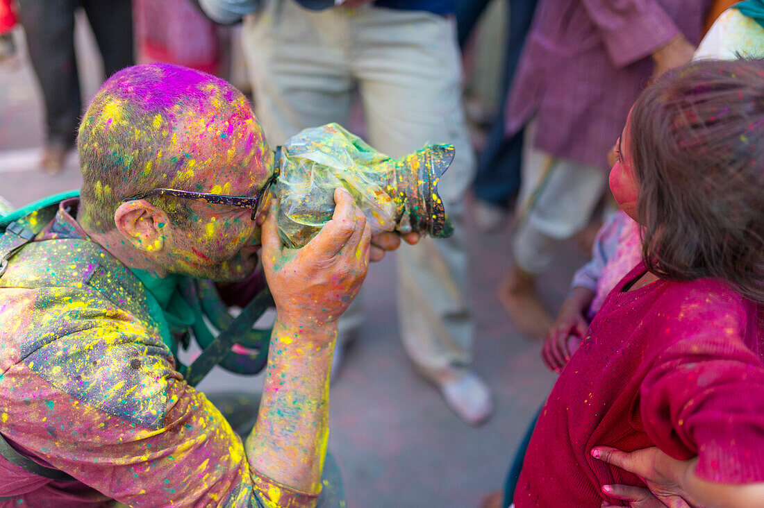 Photographer during the celebrations of the Holi festival in Mathura, Uttar Pradesh, India
