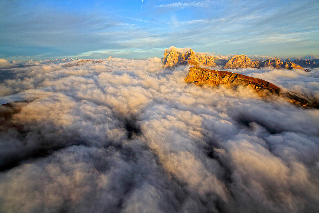 Aerial shot from Seceda of Odle surrounded by clouds at sunset, Dolomites Val Funes Trentino Alto Adige South Tyrol Italy Europe