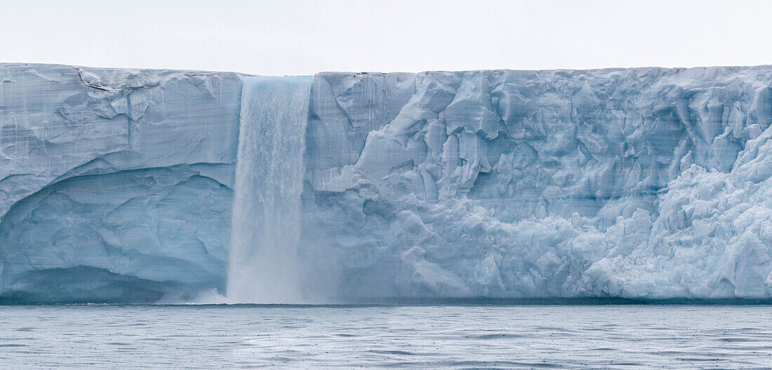 Grosser Wasserfall stürzt von Gletscherkante ins Meer Gletscher Bråsvellbreen, Nordauslandet, Spitzbergen, Svalbard