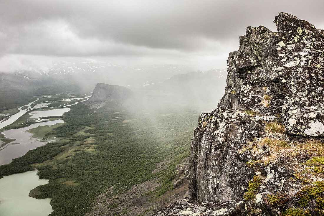 Rain and clouds over Sarek national park. View from Skierffe mountain on to Rapadalen/Laidaure Delta, Sarek national park, Laponia, Lappland, Sweden. Trekking on Kungsleden
