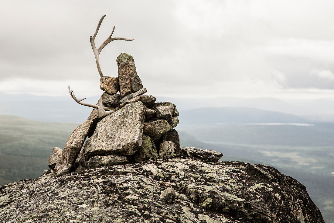 Reindeer antler on cairn. View from Skierffe mountain on to Rapadalen/Laidaure Delta, Sarek national park, Laponia, Lappland, Sweden. Trekking on Kungsleden