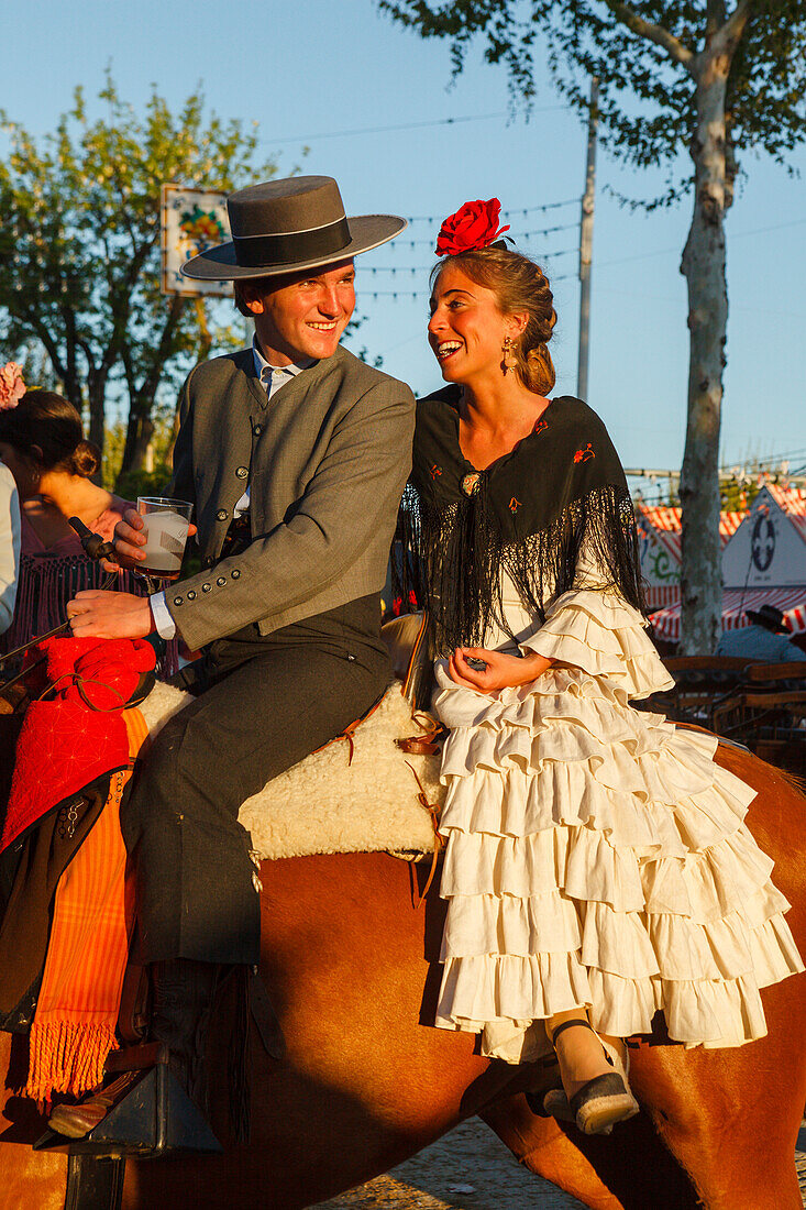 horseriding couple at the Feria de Abril, Seville Fair, spring festival, Sevilla, Seville, Andalucia, Spain, Europe