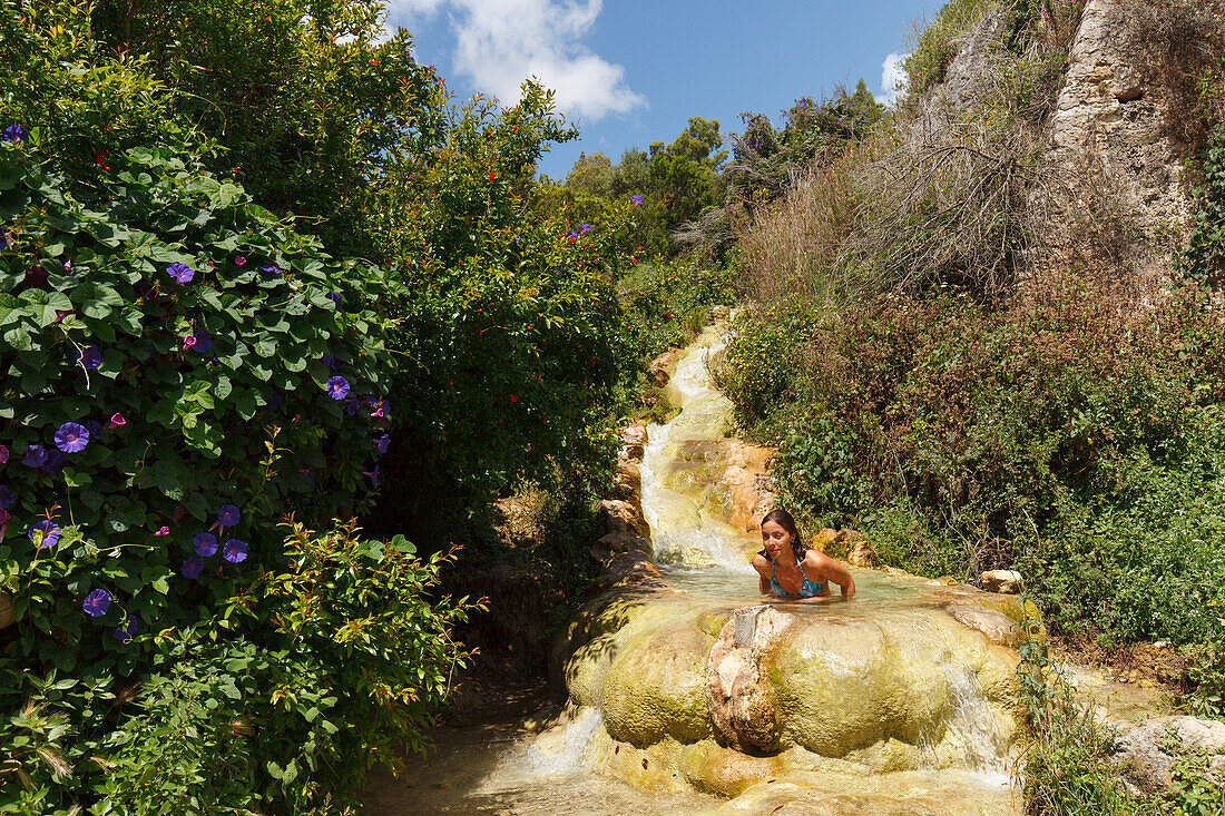 Young woman bathing in a waterfall, spring, plateau of La Muela, Santa Lucia, near Conil, Costa de la Luz, Cadiz province, Andalucia, Spain, Europe