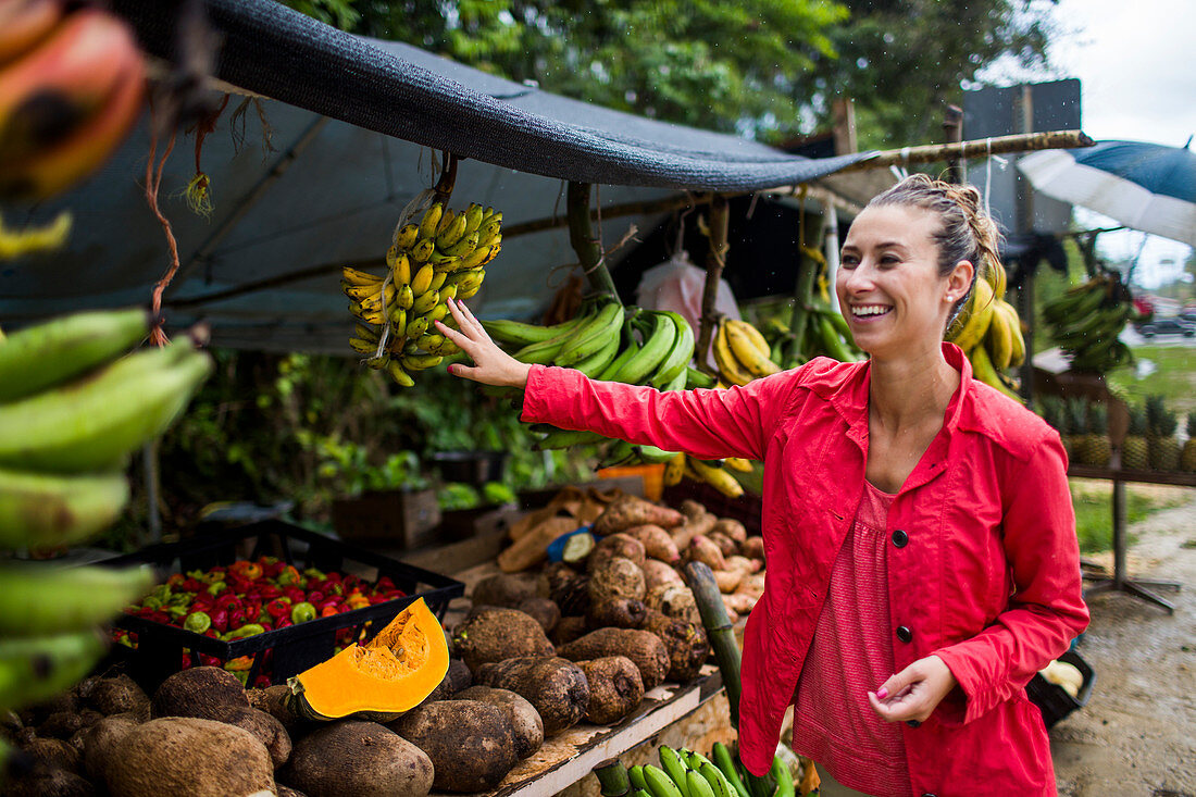 Young Woman At A Fruit Market On A Roadside In Puerto Rico