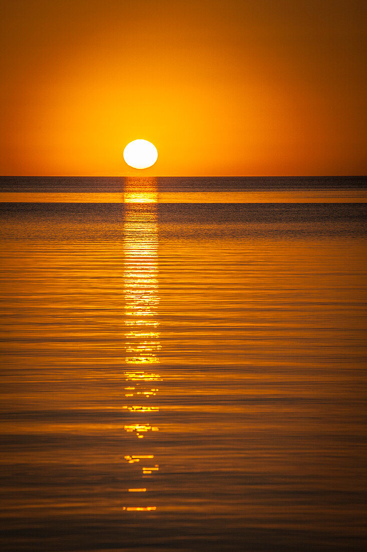 Orange sunset over the water in Belize
