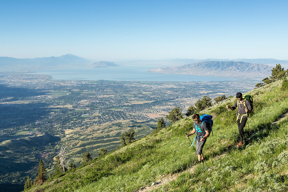 Two Men Hike Towards Utah's Lone Peak Located In The Wasatch Mountains For A Weekend Of Climbing And Camping