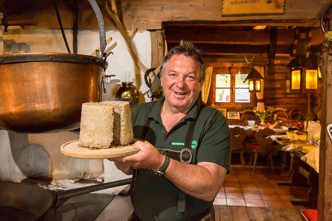 Herbert Walcher, owner of Walcheralm, with selfmade Steirerkas, Styrian cheese speciality, Dachstein area, Styria, Austria, Europe