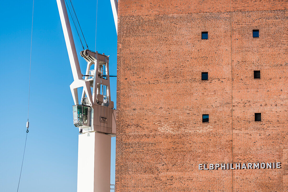 View at the Elbphilharmonie with lettering and one of the historic port cranes, Hamburg, Germany