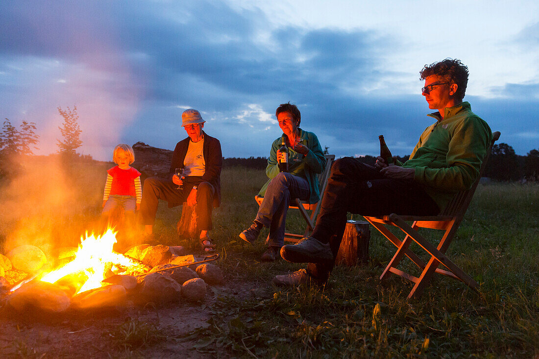 Group sitting at the campfire, Rehof Rutenberg, from dutch designers renovated old rectory, holiday apartments and garden houses, between Mecklenburg-West Pomerania and Brandenburg, Mecklenburg lakes, Mecklenburg lake district, Rutenberg, Brandenburg, Ger