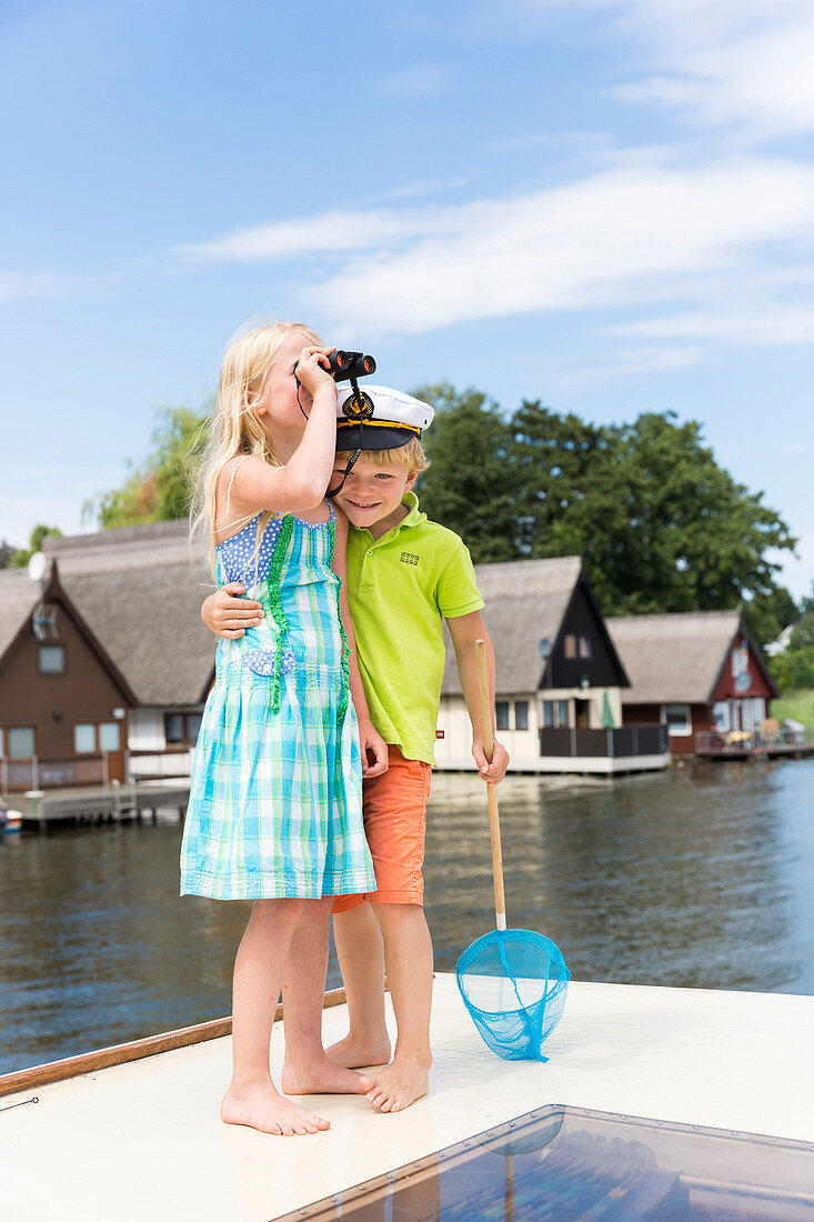 Girl and boy on boat, binocular, captain, children, houseboat tour, Lake Mirower See, Kuhnle-Tours, Mecklenburg lakes, Mecklenburg lake district, MR, Mirow, Mecklenburg-West Pomerania, Germany, Europe