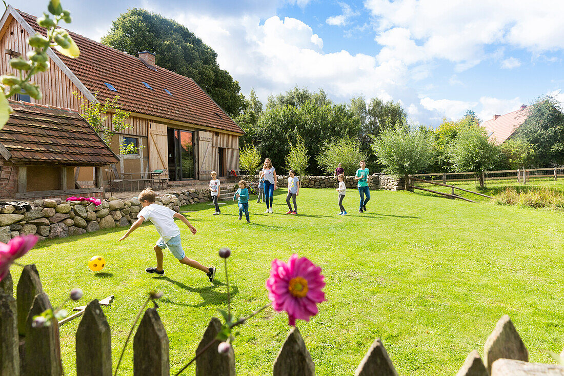 Holiday in the countryside, farm, farm house Bauernkate, garden, fence, children paying, Biosphere Reserve Schaalsee, Mecklenburg lake district, Klein Thurow, Mecklenburg-West Pomerania, Germany, Europe