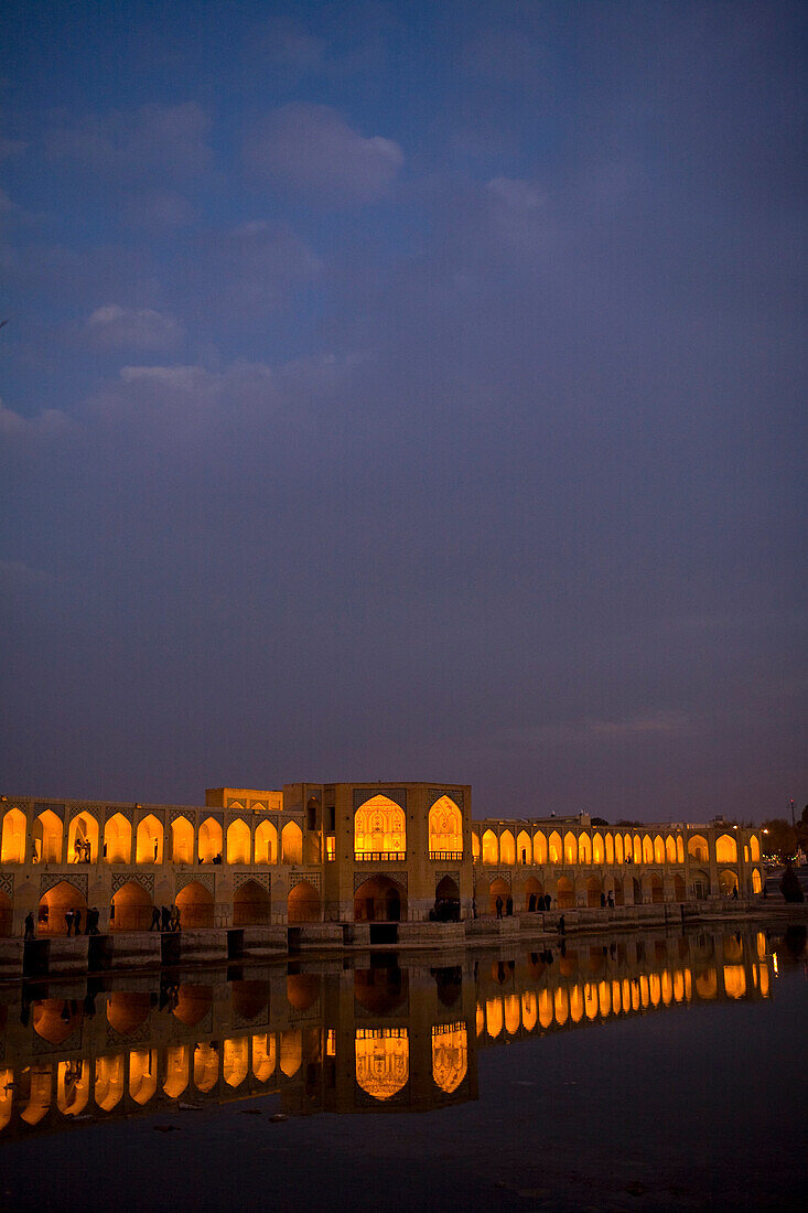 Esfahan, Iran - February, 2008: Khaju Bridge in Esfahan, Iran spans the Zayandeh River and is a popular hangout for locals in the evening.