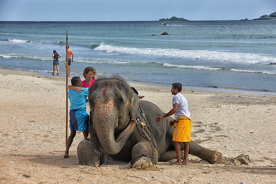Mother and daughter riding on elephant Nilaveli Beach. Sri Lanka