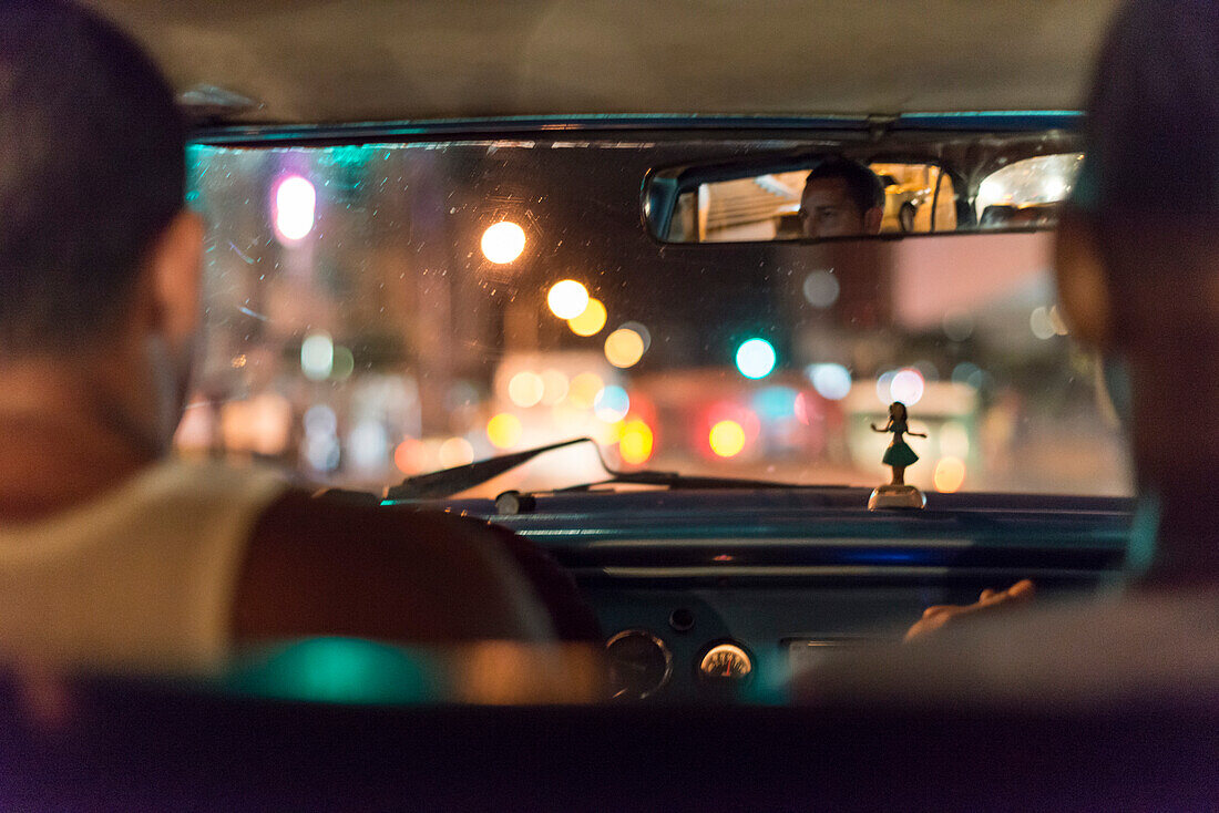 'Inside a Cuban locals only'' taxi colectivo at night. Because of the two monetary system in Cuba, and although forbidden by the Cuban government, colectivo drivers pick up tourists for payment in CUCs.. Drivers usually pick up 3-5 people per trip. The dr