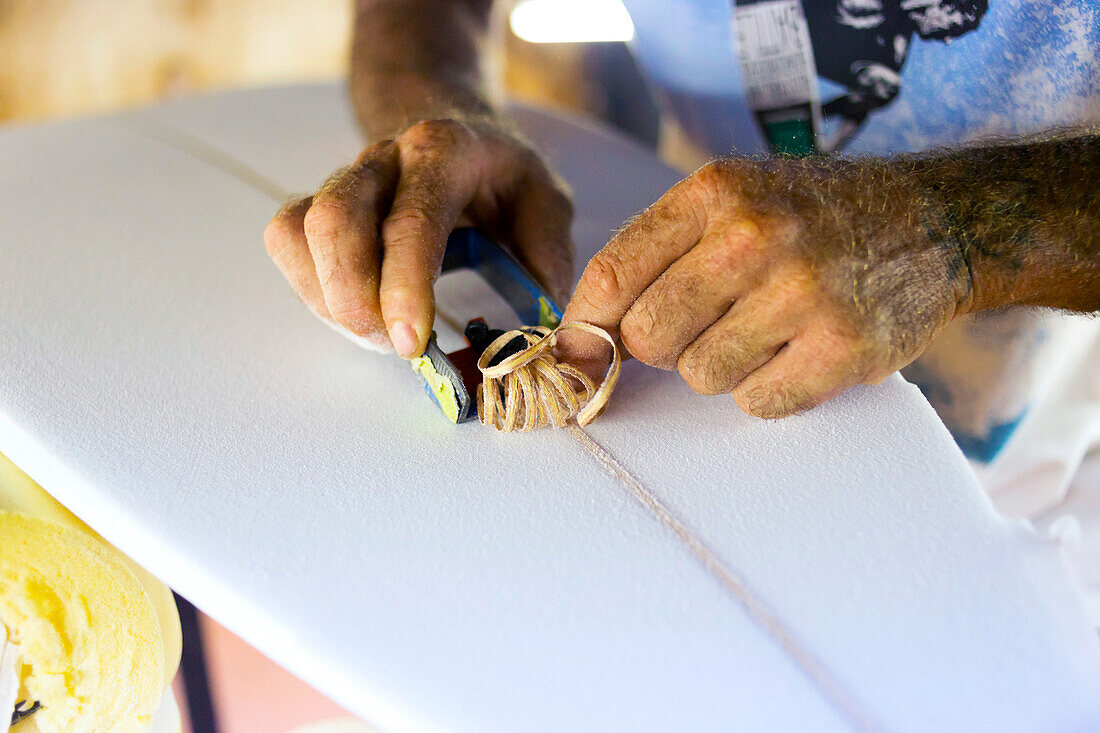 Close-up Of A Man Hand Shaping A Surfboard