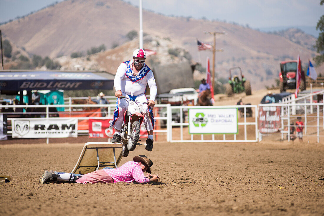 Rodeo clown performs his Evil Knievel bit during the Woodlake Lions Rodeo in Woodlake, Calif., on Sunday, May 10, 2015.