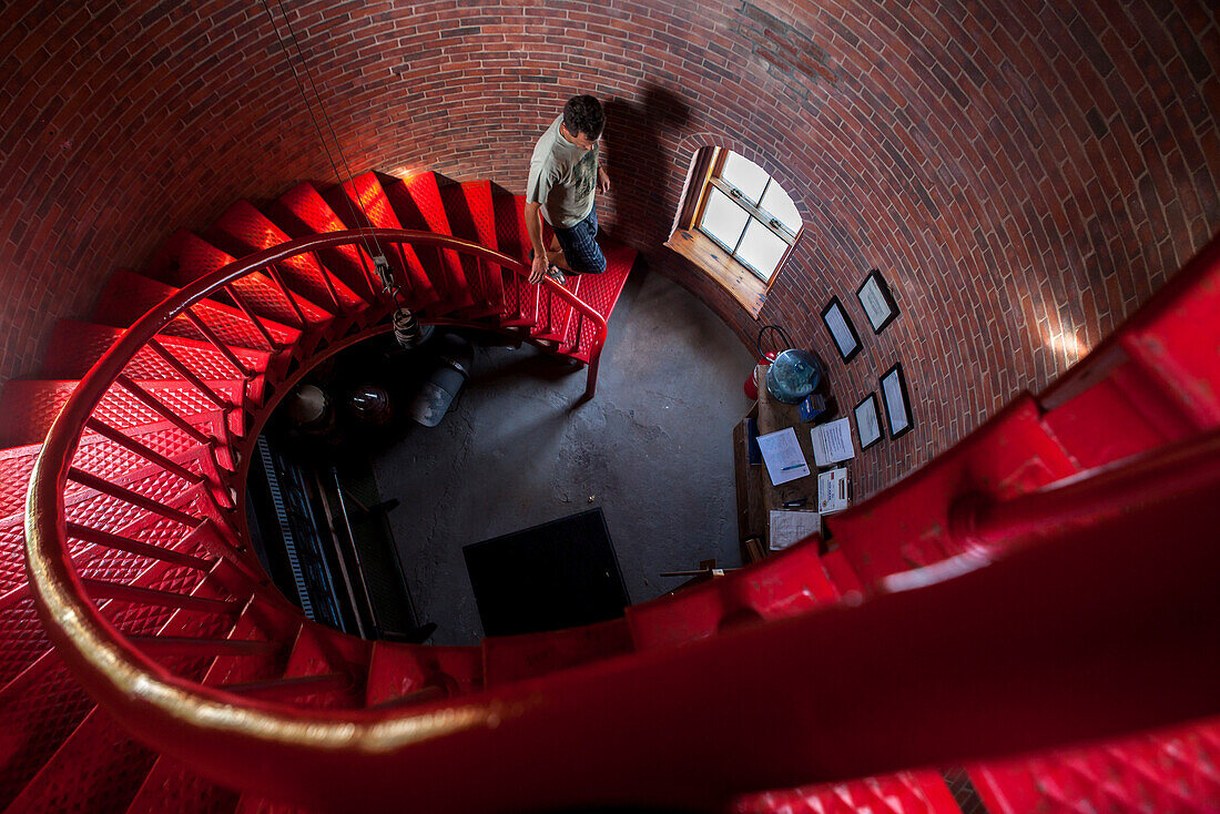 Man Walking Down The Spiral Staircase In Race Point Lighthouse