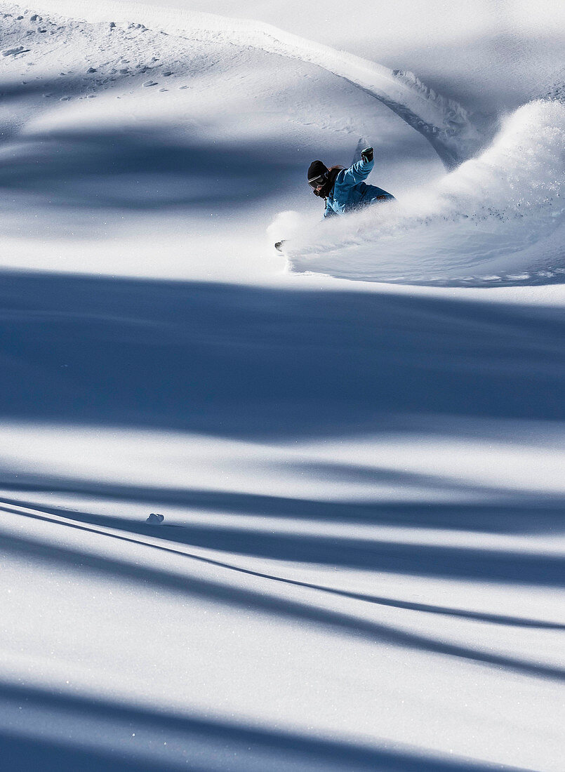 Snowboarder Makes A Turn And Sprays Powder Into The Air After A Storm