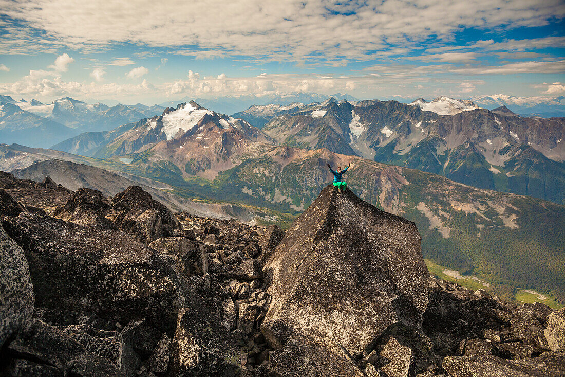 Long Exposure Of Female Climber Sitting On Top Of Mount Marriott