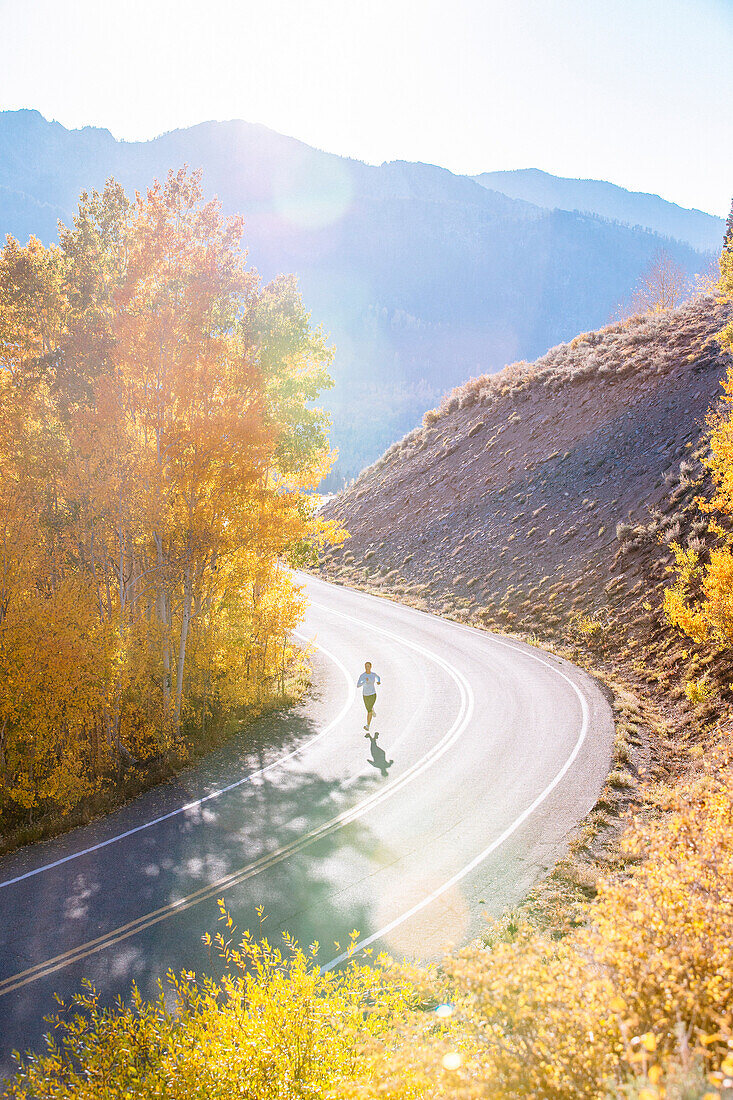 Long Exposure Of Woman Running On Road During Fall