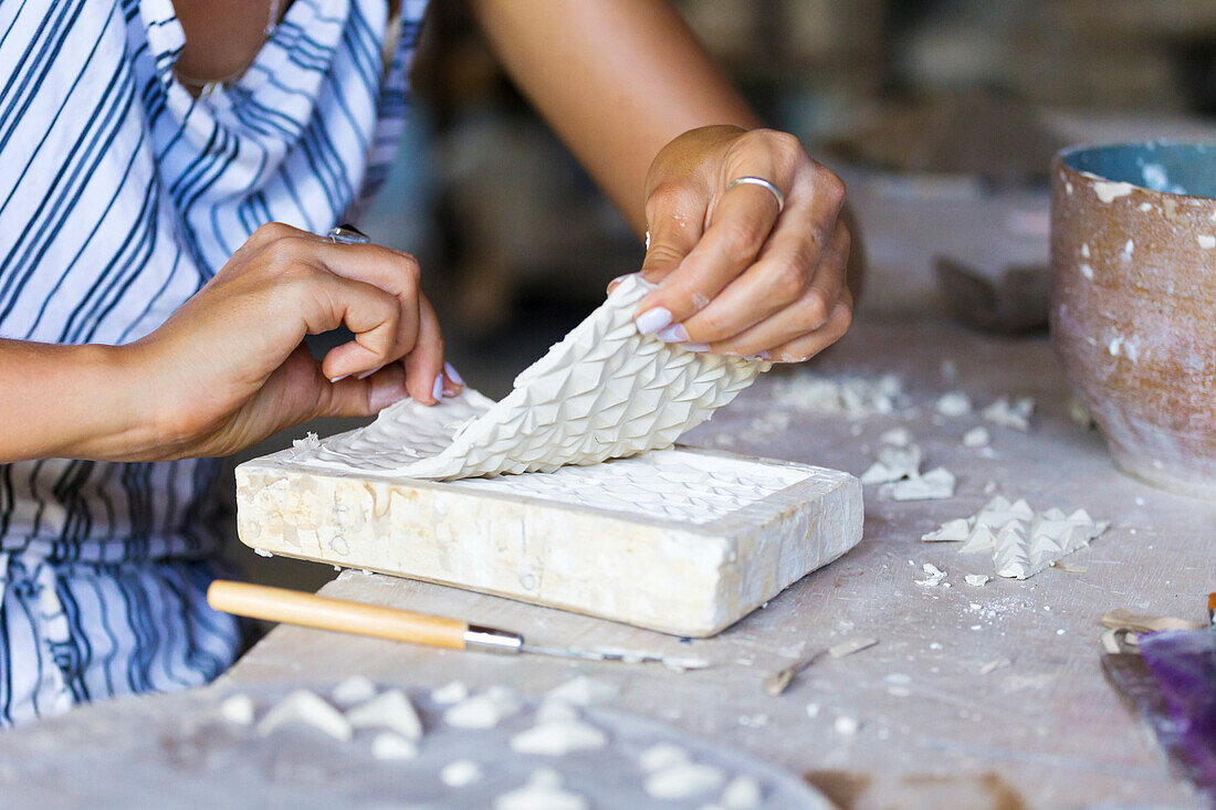 Woman Hand Using Brush On Piece Of Mold