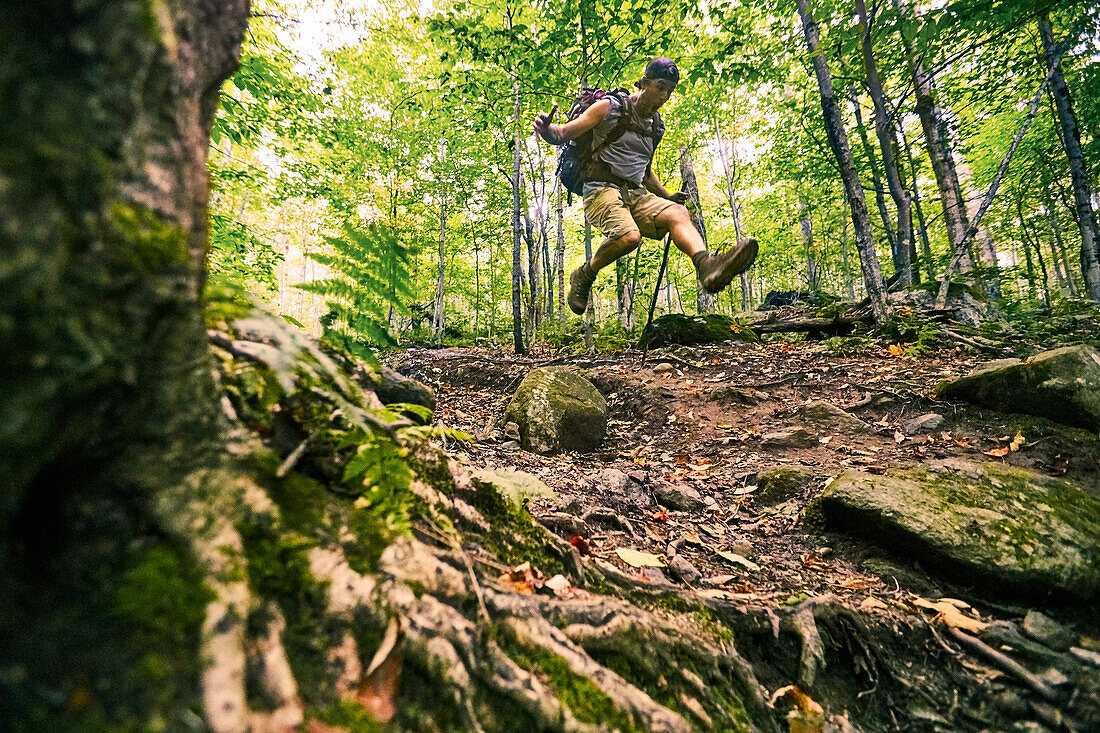 A Man Jumping While Hiking At Appalachian Trail