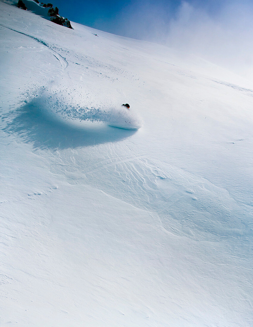 A Female Snowboarder Makes A Turn In Deep Snow At Cerro Catedral, Argentina