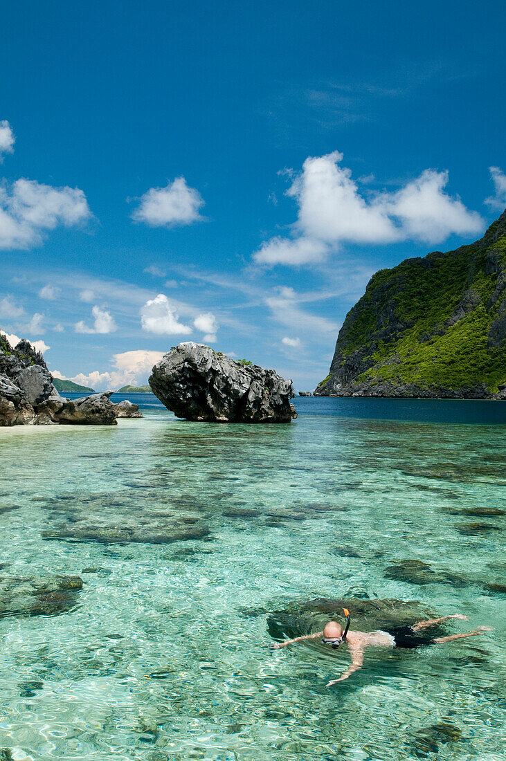 Male Snorkeler Exploring The Tropical Reefs Of El Nido In The Philippines