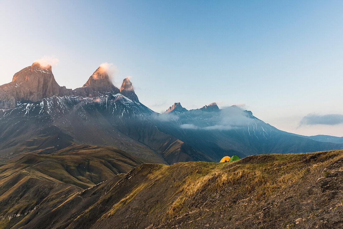Tents at sunrise in front of the Aiguille d'Arves, Savoie, Ecrins, France
