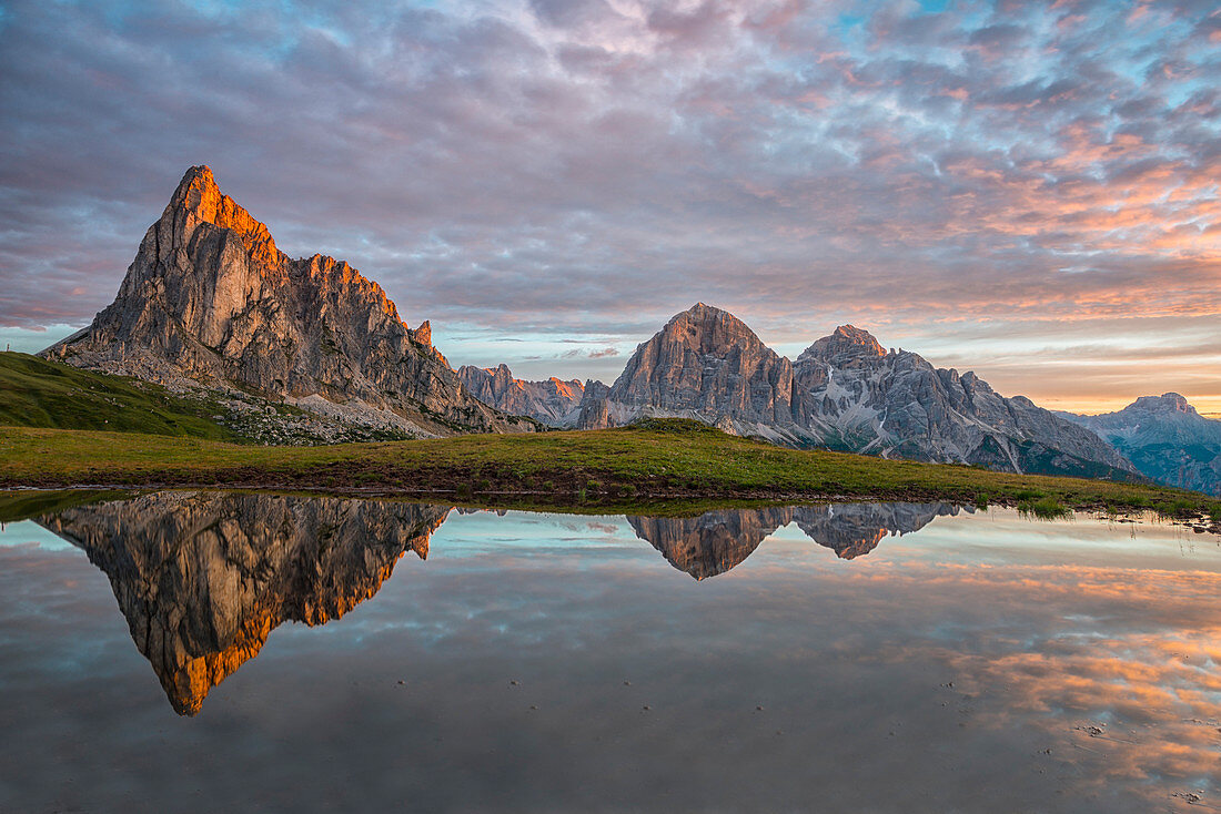 Gusela mountain at sunrise reflected in small lake, Giau Pass, Dolomites, Veneto, Italy